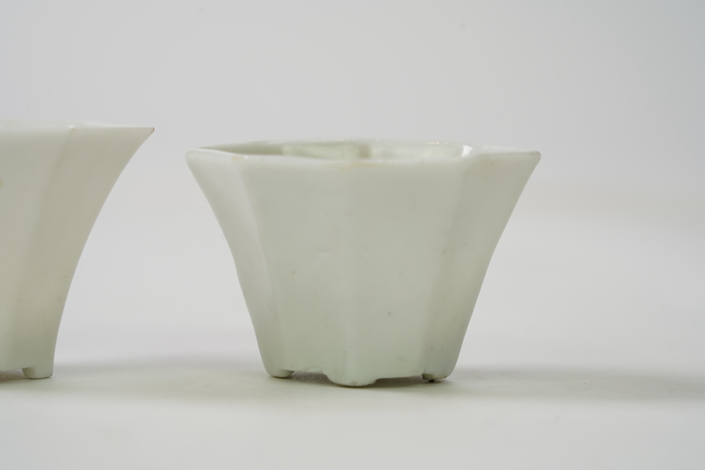 Two Chinese Dehua blanc de chine octagonal cups, Kangxi period